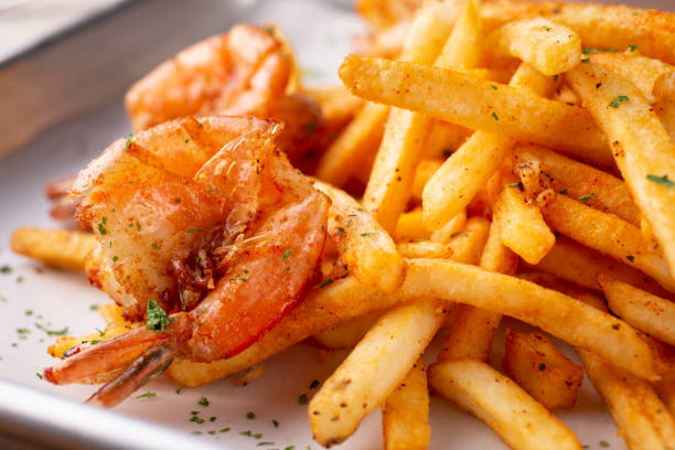 istock cajun shrimp and fries 1272726059