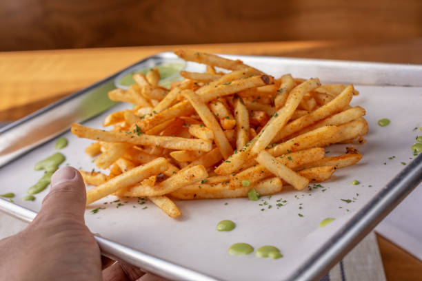 istock hand holds fries tray 1272726064