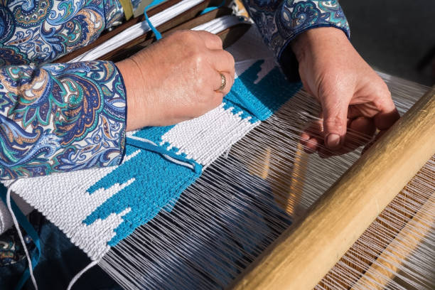istock Woman hand weaving on manual loom. 1272726195