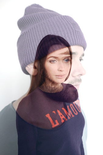 Portrait of young handsome man in violet hat and beautiful long-haired woman on white background, double exposure