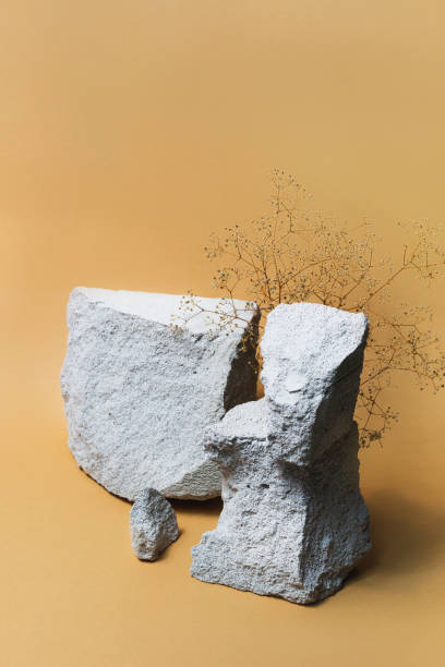 Natural stone podium for products on beige background with copyspace. Merchandise organic stage.