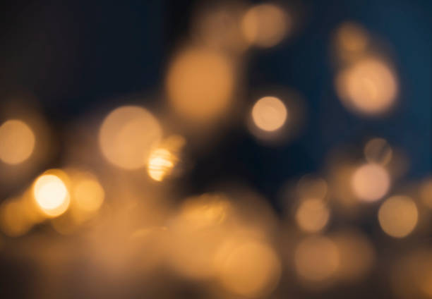 istock Defocused abstract yellow bokeh lights ondark background 1272735297