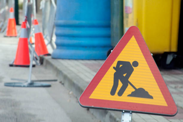 Road works ahead, road sign, traffic cones. stock photo