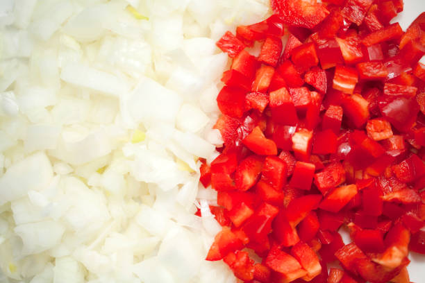 istock Chopped red bell pepper and onion on cutting board. 1272740321