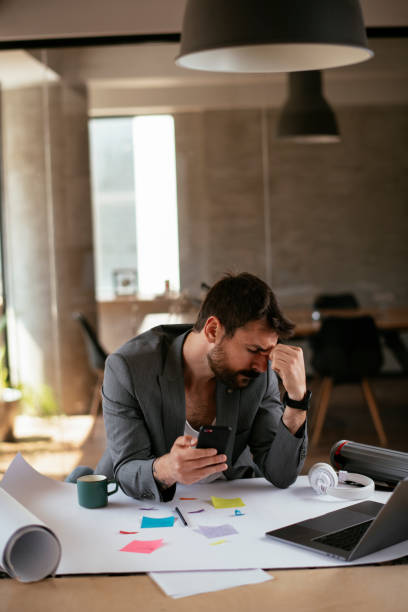 istock Tired businessman in suit working in the office. 1272742138