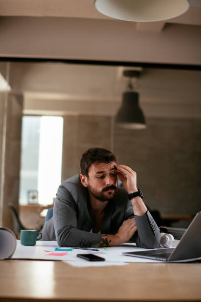 istock Tired businessman in suit working in the office. 1272742139