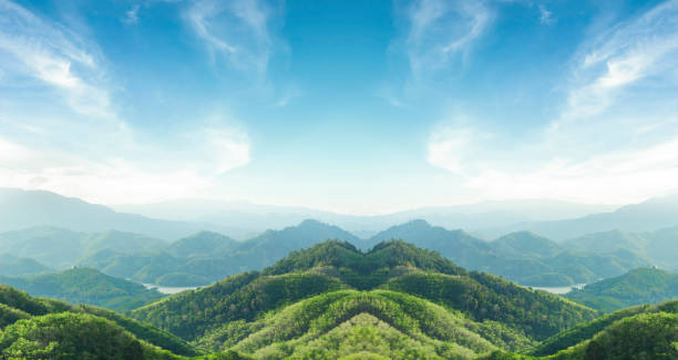 istock World environment day concept: Green mountains and beautiful blue sky clouds 1272742923