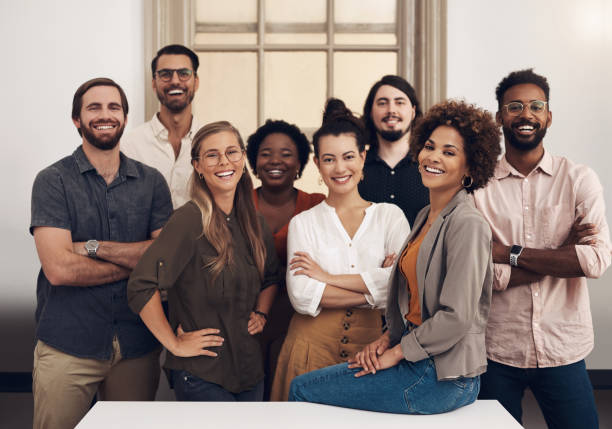 They're ready to push towards success with tenacity and confidence Portrait of a group of businesspeople standing together in an office 25 year old man portrait stock pictures, royalty-free photos & images