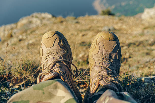 istock Man traveler in hiking boots sits on top 1272745260