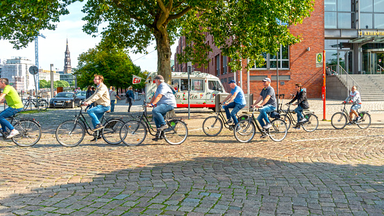 Hamburg, Germany - September 13. 2020: A group of cyclists coming from the Hafencity area in the direction of the landing stages