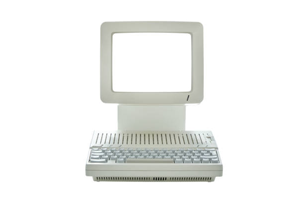 istock Vintage desktop computer with blank monitor screen isolated on white 1272746303