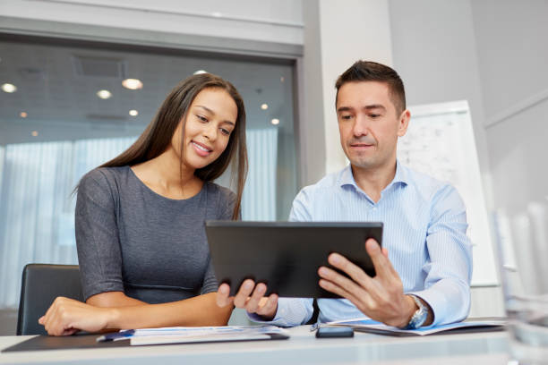 istock business team with tablet pc at office 1272748377