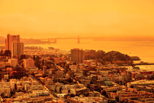 Smoky orange sky of San Francisco skyline. California fires in United States. Composition about wildfires and climate change concept.