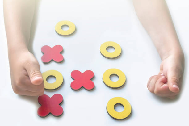 istock Kid tic-tac-toe wood board game on white background. Child won the game. Developmental game. Family and friends pastime concept. XO XO symbols. Copy space for text 1272748981