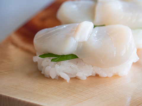 Close-up of scallop sushi. Scallop sushi with vinegared rice and green shiso.