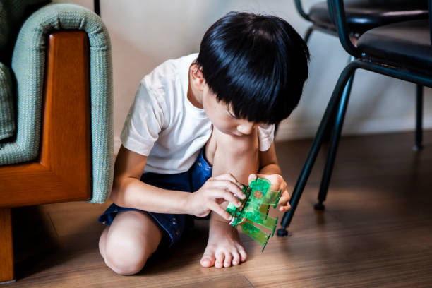 istock Boy is touching a robot toy 1272749581