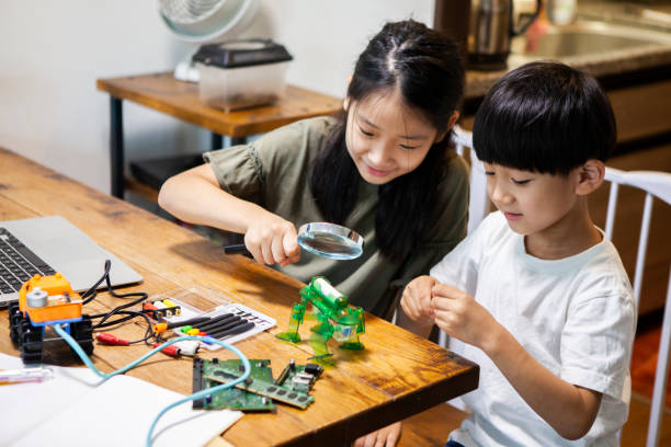 istock Children working on robot design with brothers 1272750197