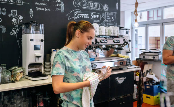 istock Waitress with mask cleaning glasses 1272750266