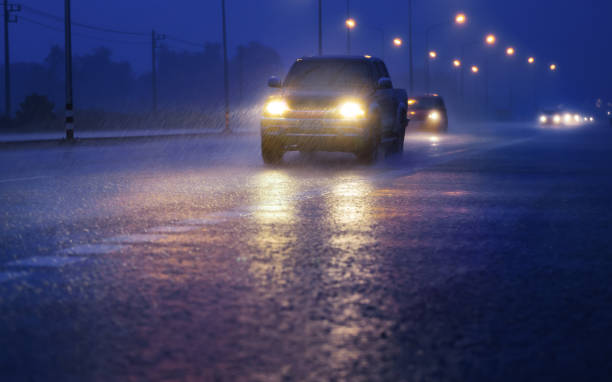 Wet road with light reflections,twilight scene during hard rain fall. stock photo