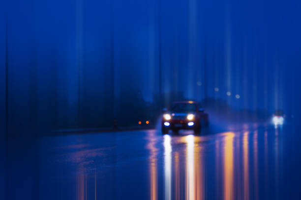 istock Wet road with light reflections,twilight scene during hard rain fall. 1272753811
