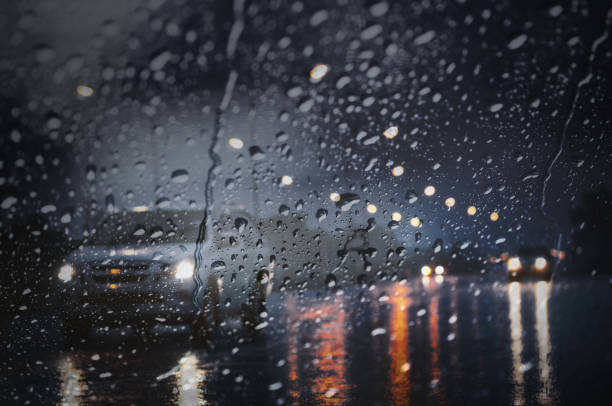 Blurry wet road with light reflections,twilight scene during hard rain fall. stock photo