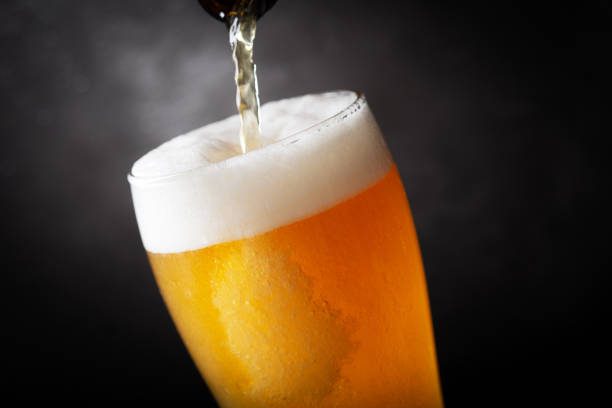 beer pouring into glass stock photo