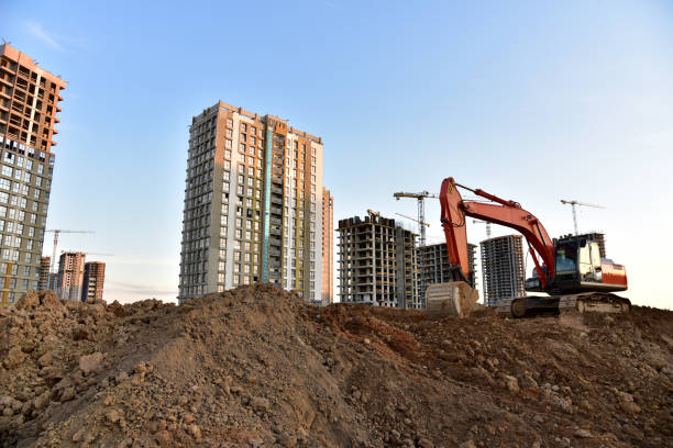istock Excavator on earthmoving at construction site. Road work and Dig pit foundation. 1272754154
