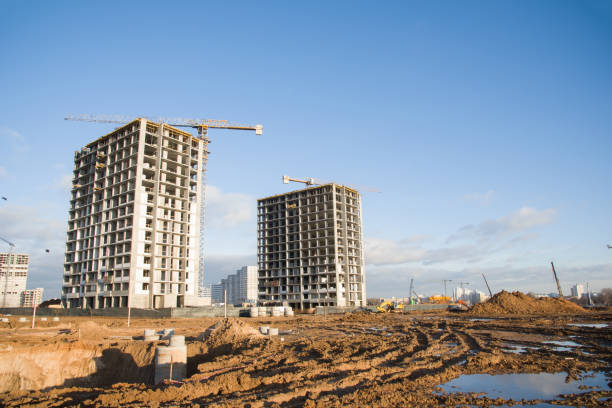 istock Tower cranes constructing a new residential build. Pouring concrete into formwork of building at construction site 1272754156