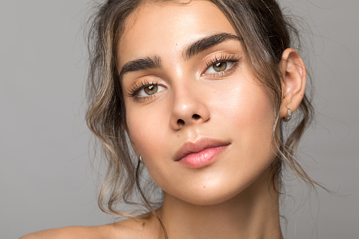 Close up studio shot of a beautiful woman with perfect skin