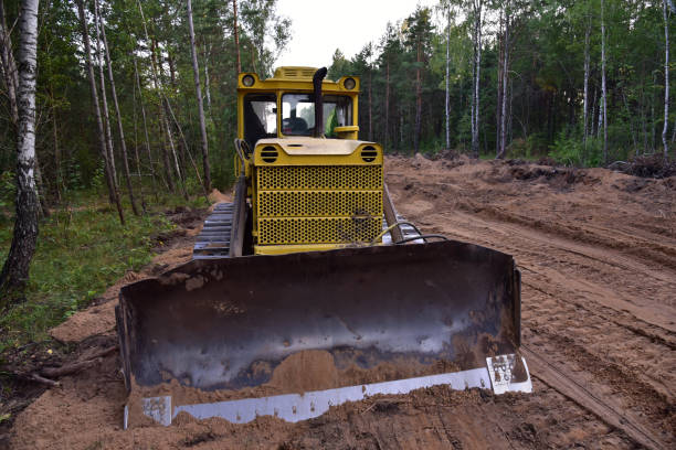istock Dozer during clearing forest for construction new road . Yellow Bulldozer at forestry work 1272760468