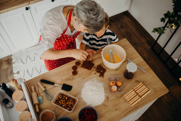 istock Grandma and grandchild bake cake 1272760602