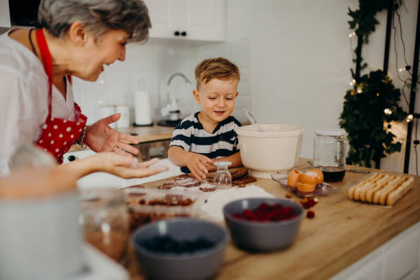 istock Grandma and grandchild bake cake 1272760936