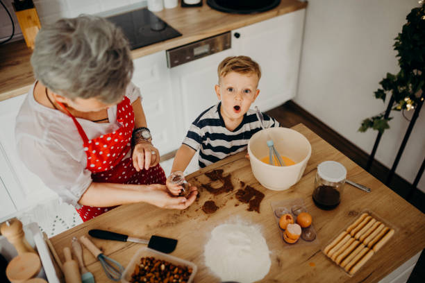 istock Grandma and grandchild bake cake 1272760987