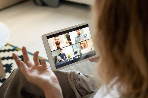istock Tablet with participants of online conference on display during communication 1272761267