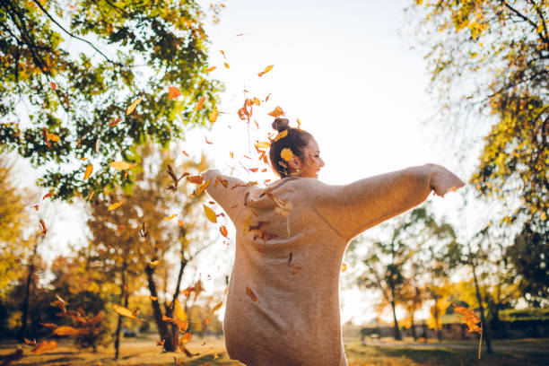 istock Happy woman in autumn park 1272762040