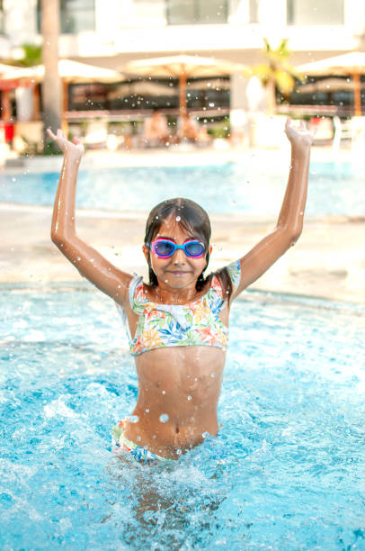 istock Happy child girl posing by the pool 1272762561