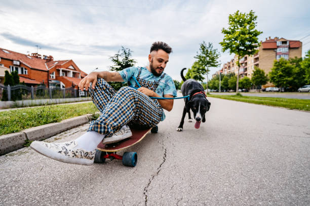 istock Man skateboarding with his dog 1272763494