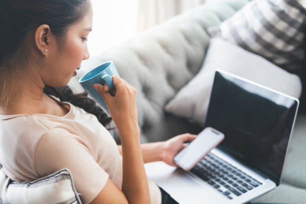 istock Woman working on laptop and drinking coffee 1272763591