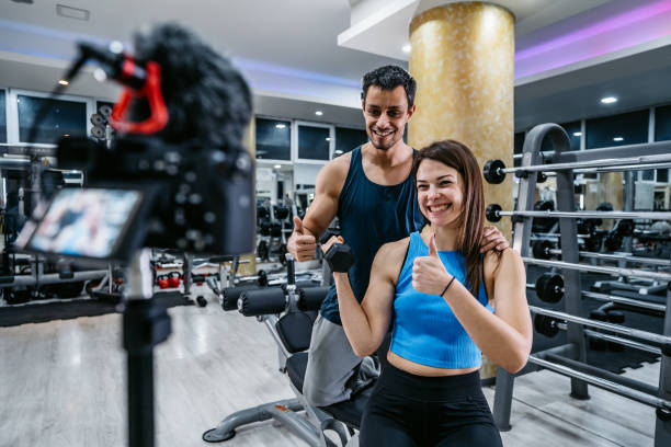 istock Woman and her trainer making exercise vlog 1272764325