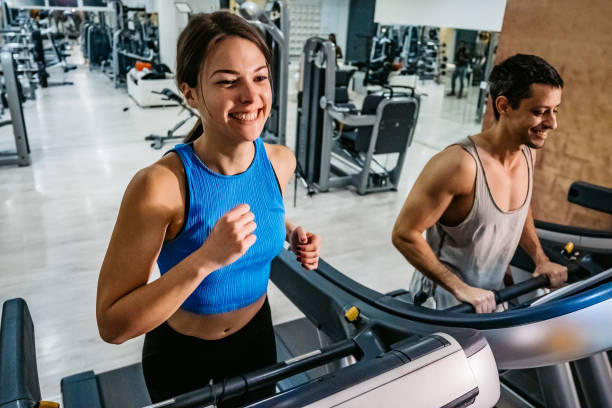 istock Woman running on treadmill in gym 1272764501