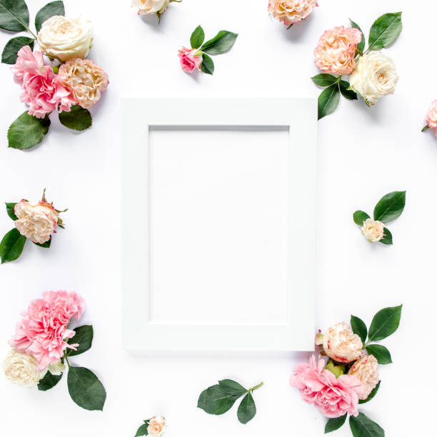 istock roses and cloves, branches, floral pattern on white background. Flat lay, top view. Valentine's background. Floral frame. Frame of flowers 1272767490