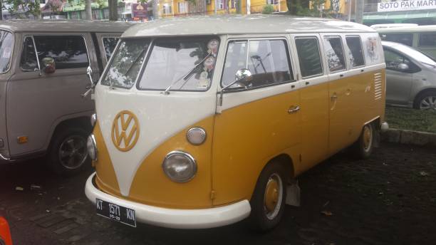 Full length front view from a VW Bulli, Nr. 1, VW Combi, 2 windows, yellow white. on an exhibition in Yogyakarta, Java, Indonesia on November 19, 2017