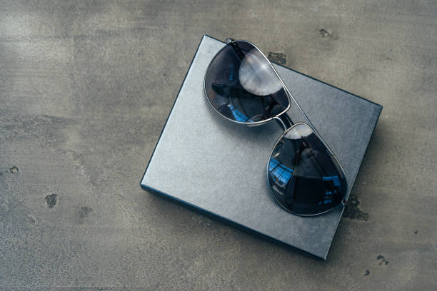 istock New dark aviator glasses on grey concrete background 1272768914