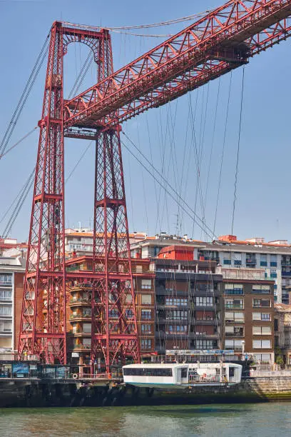 Bizkaia red iron hanging bridge and Nervion river. Euskadi, Spain