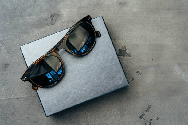 Dark male sunglasses on grey concrete surface