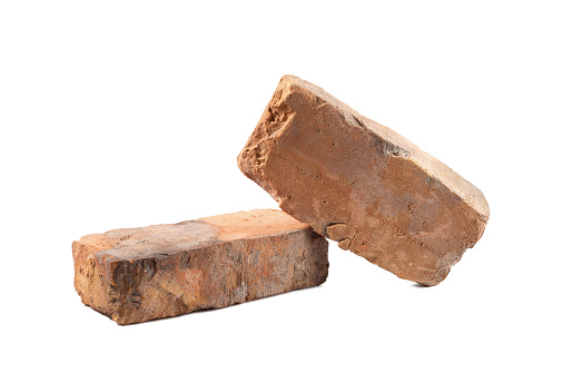 Solid red clay bricks used for construction isolated on white background.