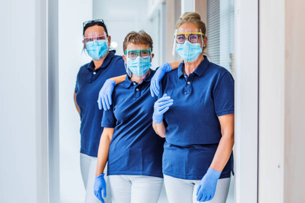three female medical assistants in a surgery - dentist office nurse doctors office blond hair imagens e fotografias de stock