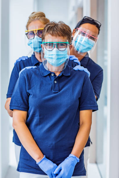 three female medical assistants in a surgery - dentist office nurse doctors office blond hair imagens e fotografias de stock