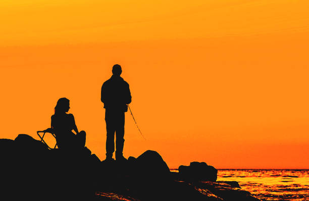 couple on the sunset rocky shore