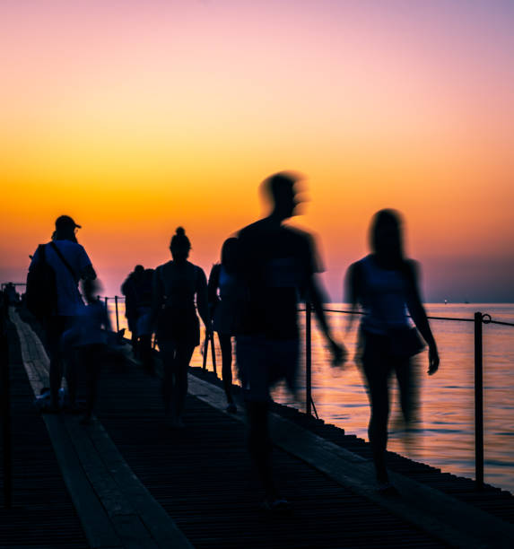 istock people on pier at sunset 1272774049